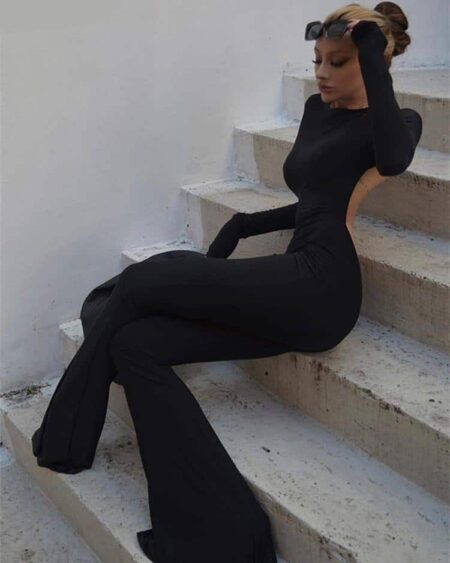 Femme assise dans un escalier dans une combinaison noire