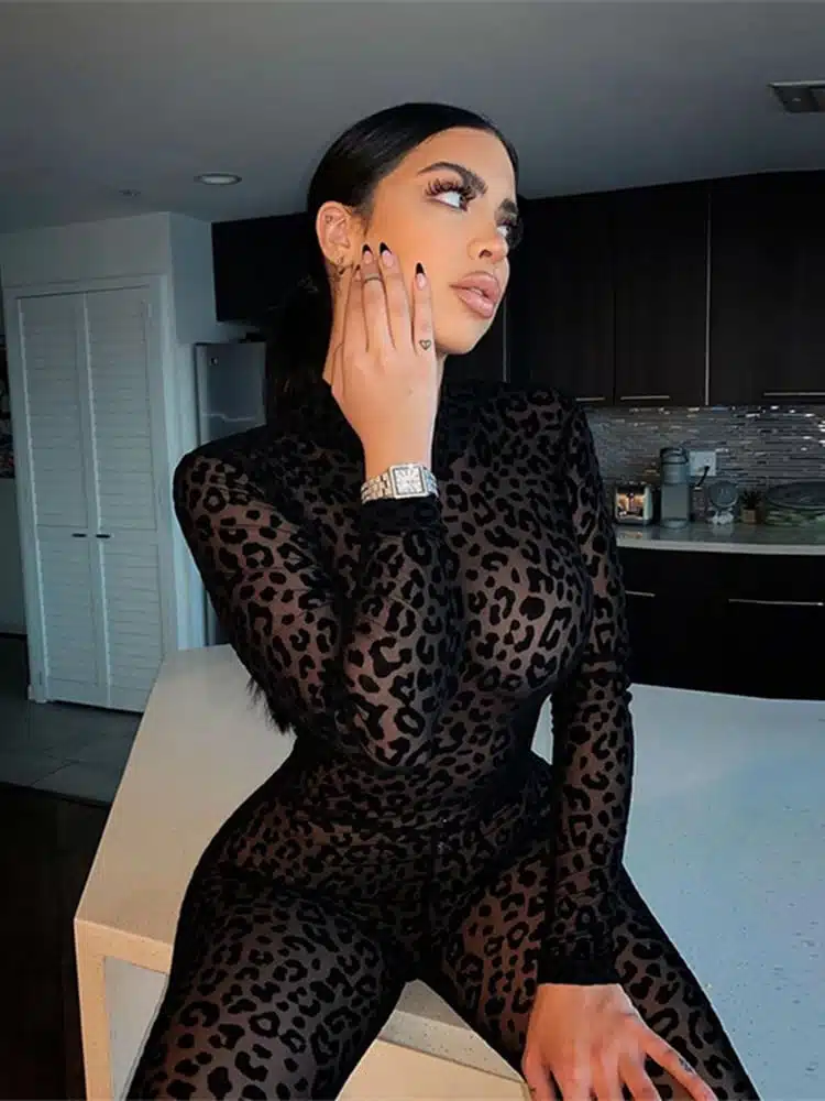 Femme portant une combinaison noire transparente à imprimé léopard.